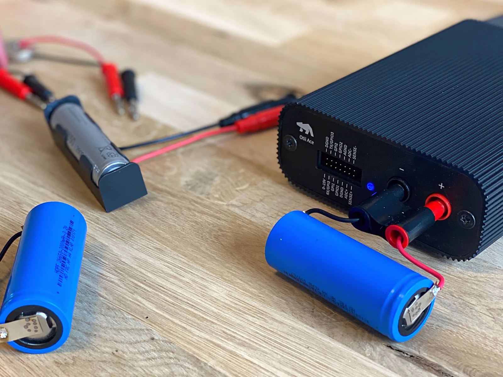 An Otii Ace power profiler wired up to an 18650 battery cell on the bench