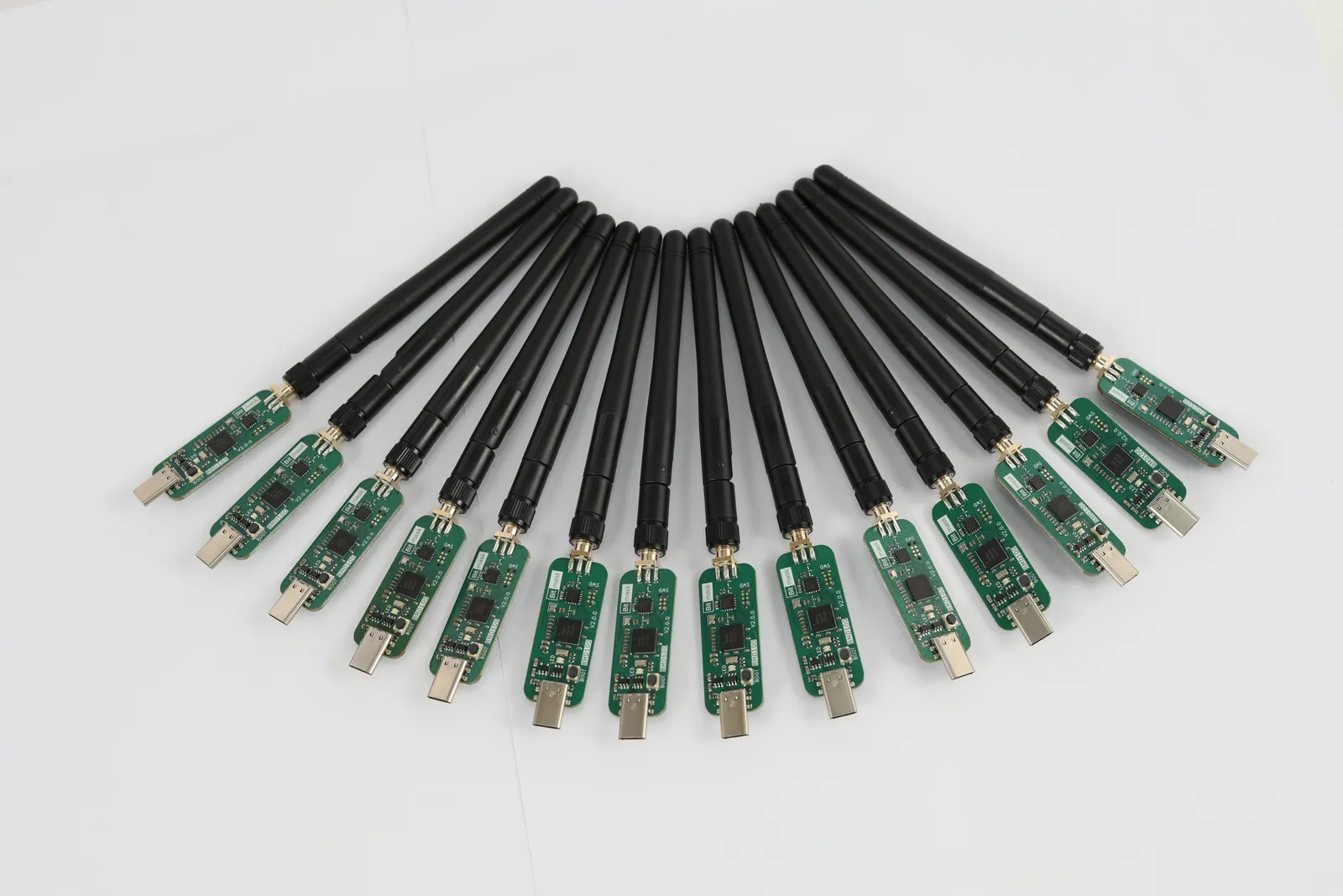 A row of BMD100 dongles with antennas attached, arranged in an arc