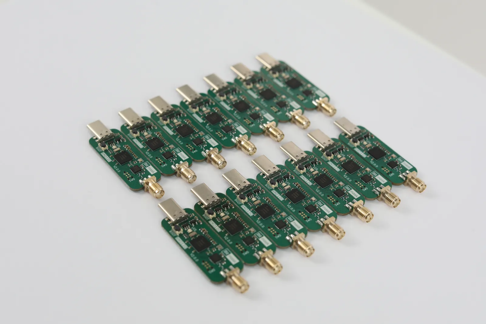 A batch of bare BMD100 boards without antennas, showing the USB-C and SMA connectors