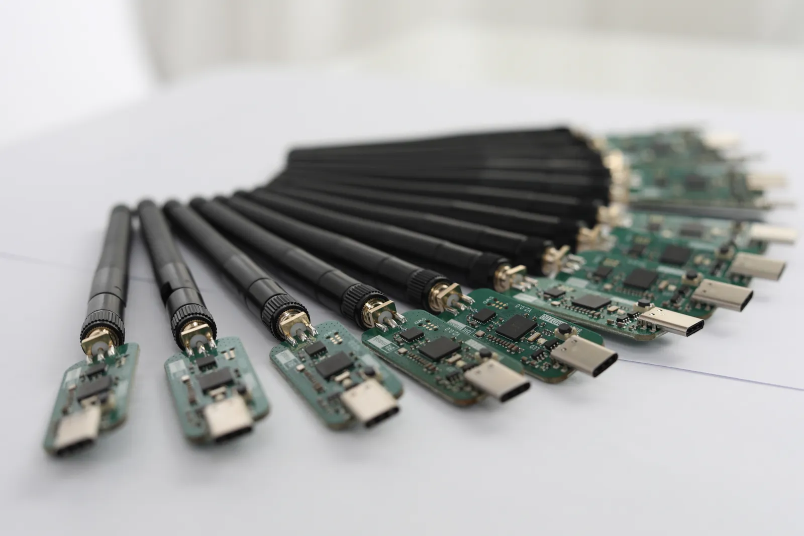Several BMD100 dongles with antennas fitted, fanned out in a semicircle